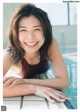 A woman in a swimming pool smiling at the camera.